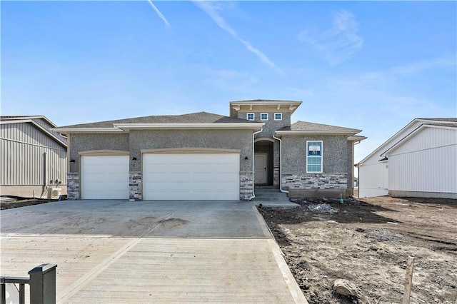 view of front of property with a garage, stone siding, driveway, and stucco siding