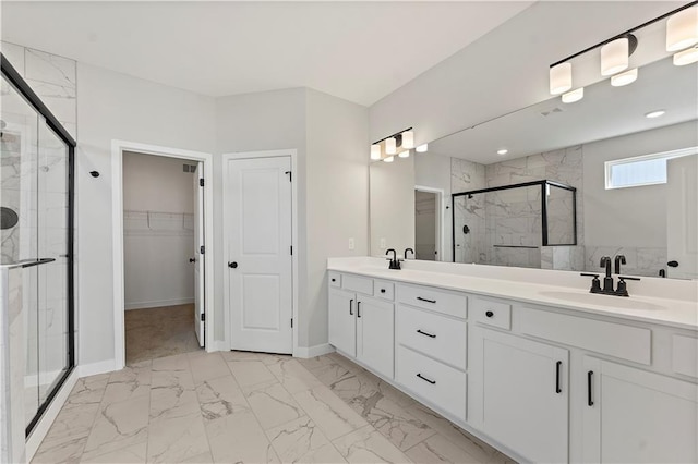 bathroom featuring a stall shower, marble finish floor, a sink, and a spacious closet