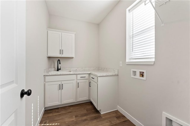 laundry room featuring cabinet space, baseboards, dark wood-style flooring, washer hookup, and a sink