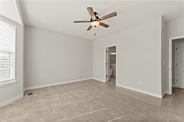 unfurnished bedroom with carpet, visible vents, and baseboards