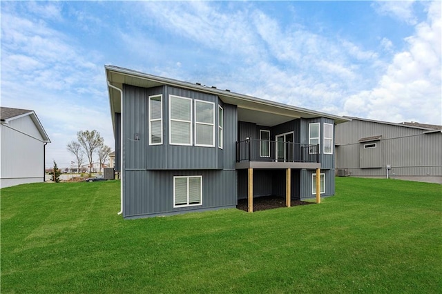 rear view of property featuring a lawn