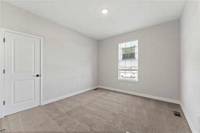 empty room with recessed lighting, carpet floors, visible vents, and baseboards