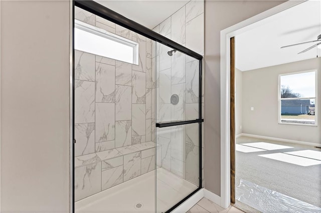 bathroom featuring a stall shower, ceiling fan, marble finish floor, and baseboards