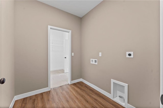 laundry area with hookup for an electric dryer, laundry area, washer hookup, wood finished floors, and baseboards