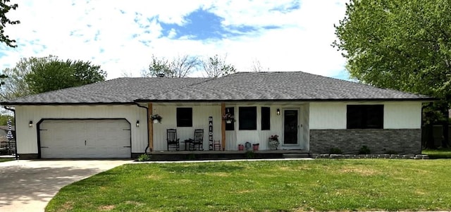 ranch-style house featuring a front lawn, a garage, and covered porch