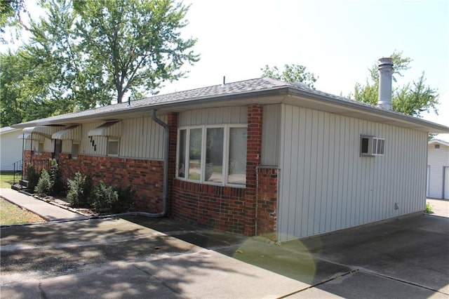 view of side of property featuring an AC wall unit