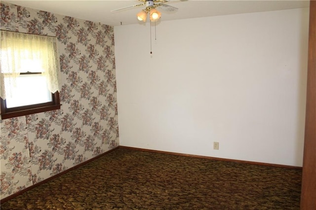 carpeted spare room with ceiling fan