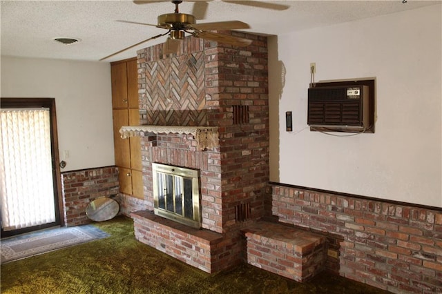 unfurnished living room featuring a textured ceiling, a fireplace, carpet flooring, and ceiling fan