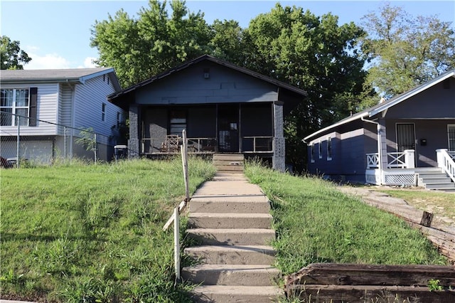 bungalow-style home with a front yard