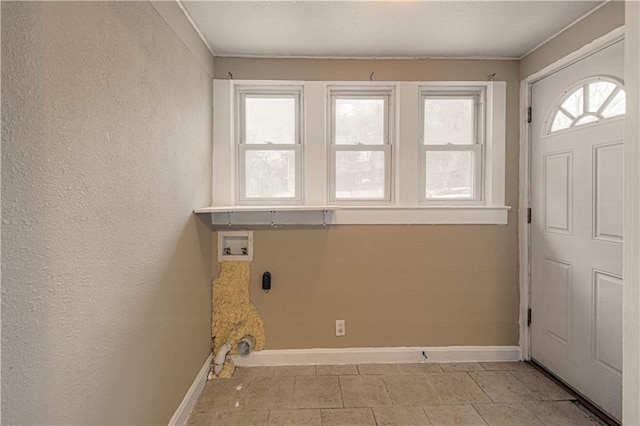 clothes washing area with laundry area, hookup for a washing machine, baseboards, and a textured wall