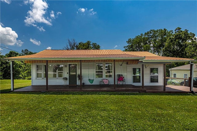 rear view of property with a lawn