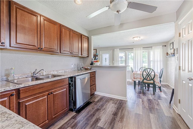 kitchen featuring dishwasher, a textured ceiling, dark wood-type flooring, sink, and ceiling fan