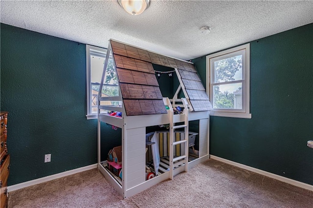 bedroom featuring a textured ceiling and carpet floors