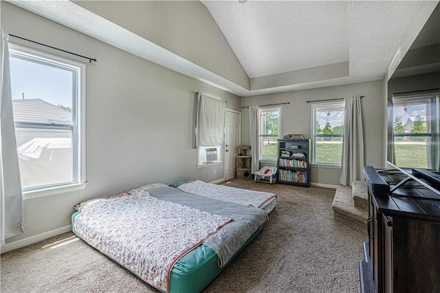 bedroom with a textured ceiling, carpet, and lofted ceiling