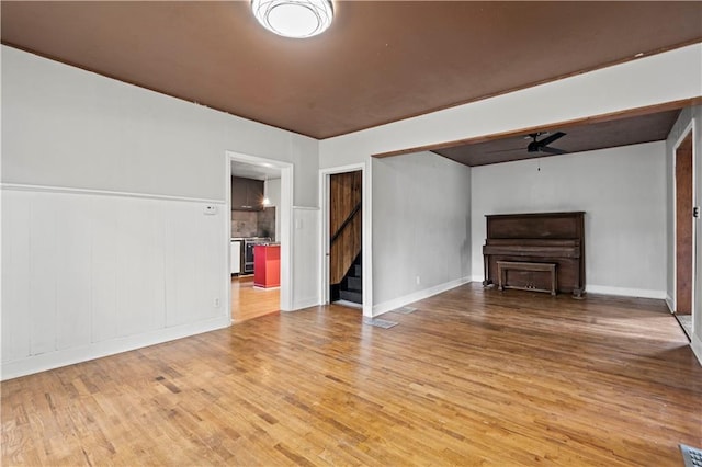 unfurnished living room with hardwood / wood-style floors and ceiling fan