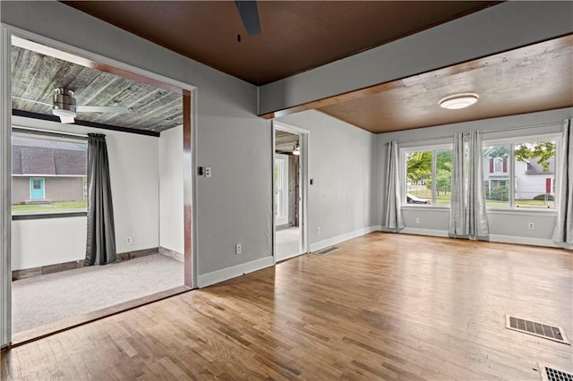 spare room with hardwood / wood-style flooring and ceiling fan