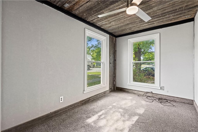 carpeted spare room with wood ceiling and ceiling fan