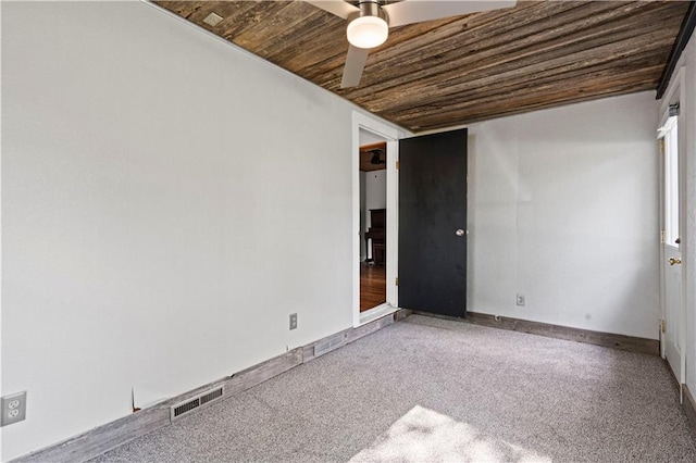 carpeted empty room featuring wooden ceiling and ceiling fan