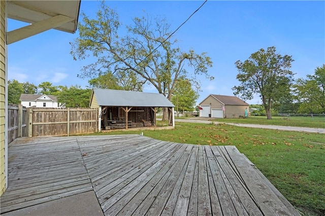 wooden deck with an outdoor structure and a lawn