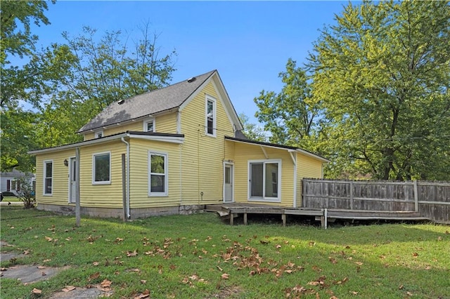 rear view of property featuring a yard