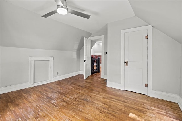 bonus room with lofted ceiling, hardwood / wood-style floors, and ceiling fan