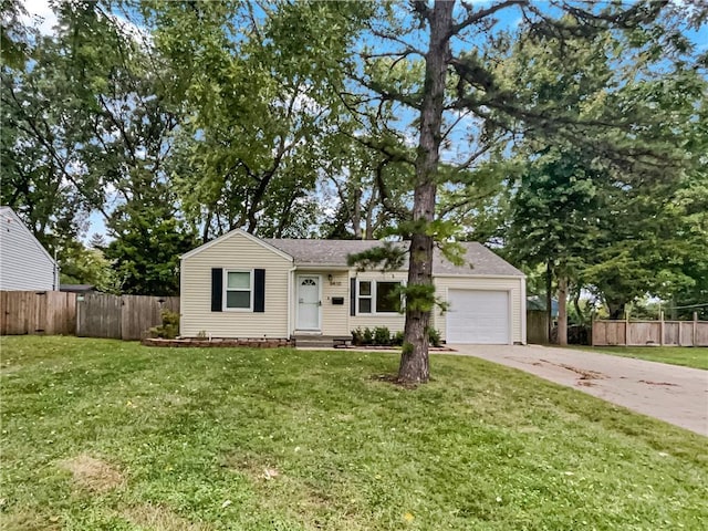 ranch-style home with a garage and a front lawn