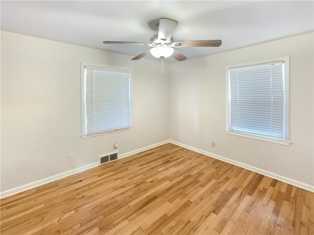 spare room featuring light wood-type flooring and ceiling fan