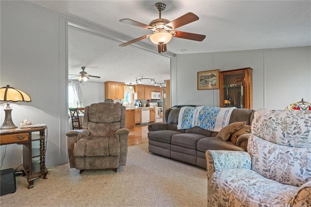 living room with ceiling fan and lofted ceiling