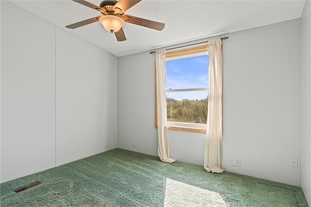 carpeted empty room with ceiling fan and visible vents