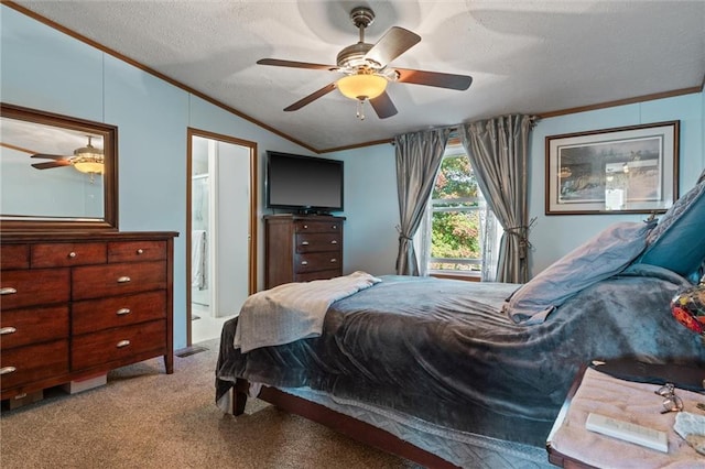 carpeted bedroom featuring ensuite bath, ornamental molding, a textured ceiling, vaulted ceiling, and ceiling fan