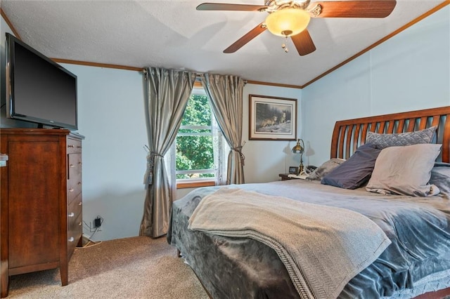 carpeted bedroom with lofted ceiling, ceiling fan, and crown molding