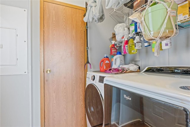 washroom with electric panel and washing machine and clothes dryer