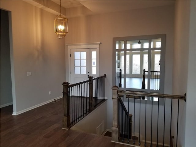 interior space with dark hardwood / wood-style floors and a notable chandelier