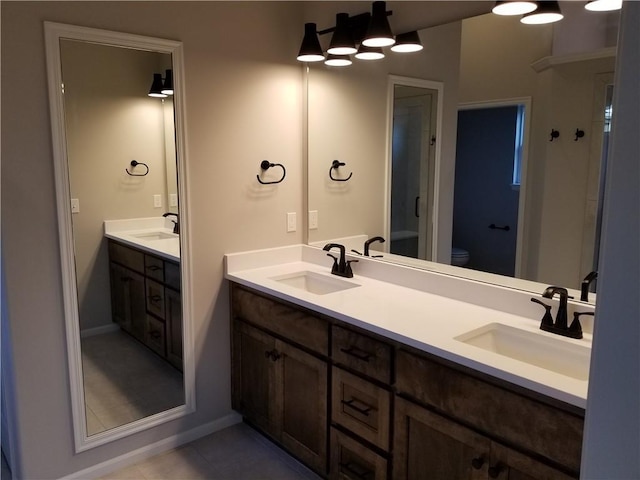 bathroom featuring tile patterned flooring, vanity, and toilet