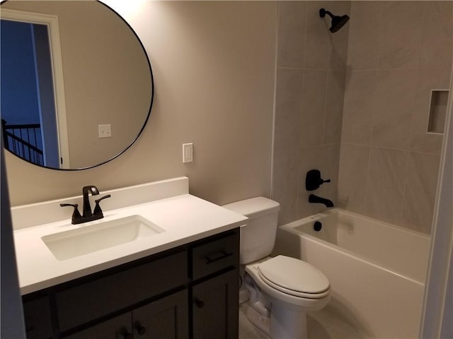 full bathroom featuring vanity, tiled shower / bath combo, and toilet