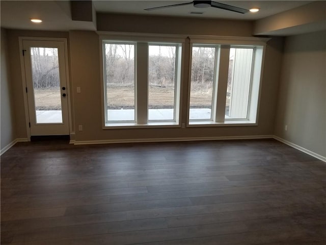 interior space featuring dark wood-type flooring and ceiling fan