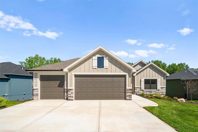 14566 Aurora Ln, Basehor, KS 66007 - craftsman house featuring board and batten siding, stone siding, a front yard, driveway, and a garage