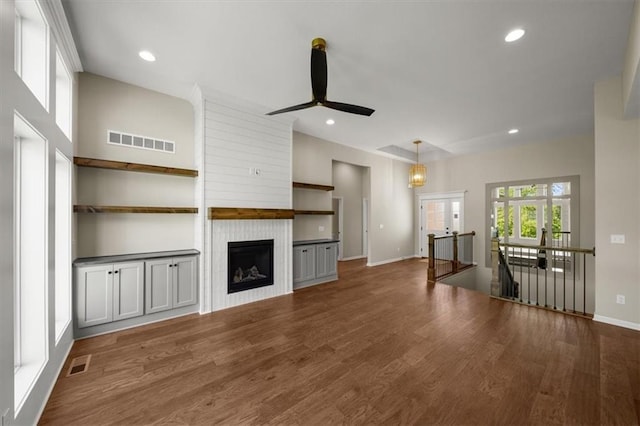 14566 Aurora Ln, Basehor, KS 66007 - unfurnished living room featuring a ceiling fan, wood finished floors, baseboards, a fireplace, and recessed lighting