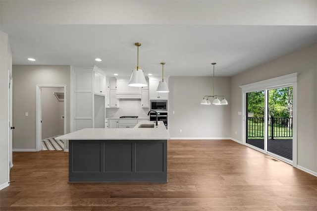 14566 Aurora Ln, Basehor, KS 66007 - kitchen featuring baseboards, a sink, white cabinets, light countertops, and appliances with stainless steel finishes