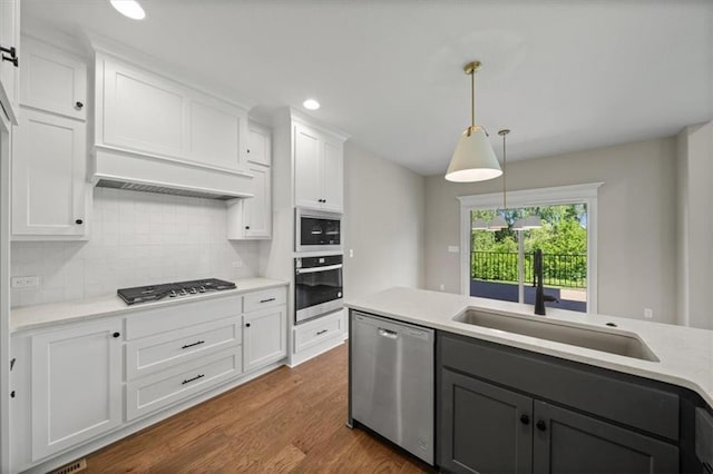 14566 Aurora Ln, Basehor, KS 66007 - kitchen with stainless steel appliances, white cabinets, tasteful backsplash, a sink, and recessed lighting
