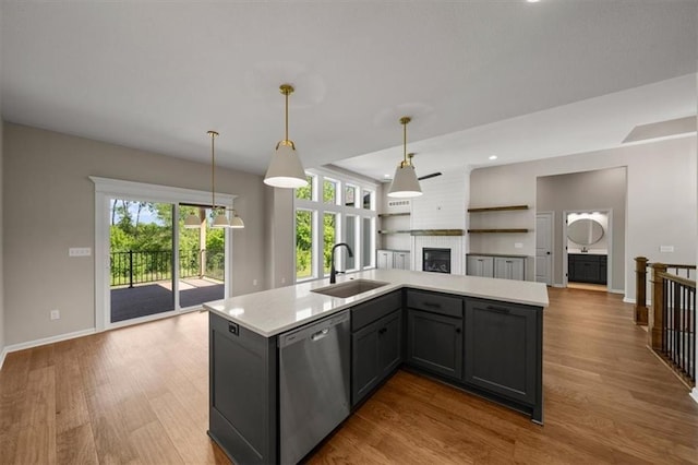 14566 Aurora Ln, Basehor, KS 66007 - kitchen with dishwasher, a sink, a large fireplace, light countertops, and open floor plan