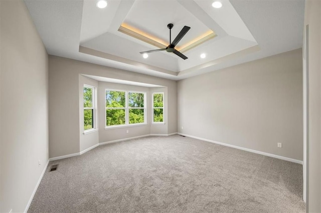 14566 Aurora Ln, Basehor, KS 66007 - empty room featuring a tray ceiling, carpet flooring, a ceiling fan, baseboards, and recessed lighting