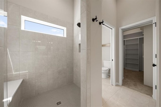 14566 Aurora Ln, Basehor, KS 66007 - full bathroom with a tile shower, tile patterned flooring, toilet, and a walk in closet