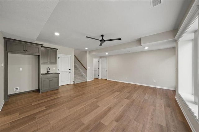 14566 Aurora Ln, Basehor, KS 66007 - unfurnished living room with ceiling fan, recessed lighting, stairway, light wood-type flooring, and baseboards