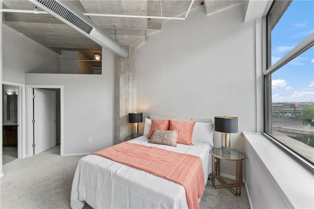 bedroom with carpet flooring and a high ceiling