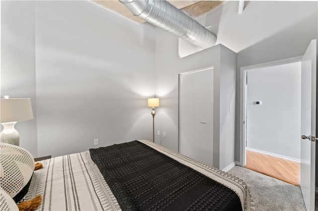 carpeted bedroom featuring a high ceiling