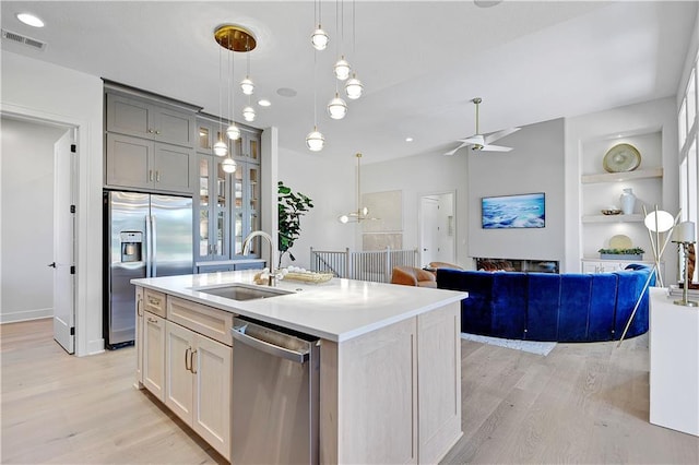 25134 W 98th Pl, Lenexa, KS 66227 - kitchen with appliances with stainless steel finishes, light wood-style flooring, ceiling fan, and built in shelves