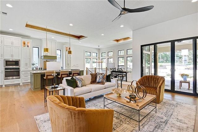 25110 W 98th Pl, Lenexa, KS 66227 - living area with a ceiling fan, light wood-style flooring, recessed lighting, and a raised ceiling