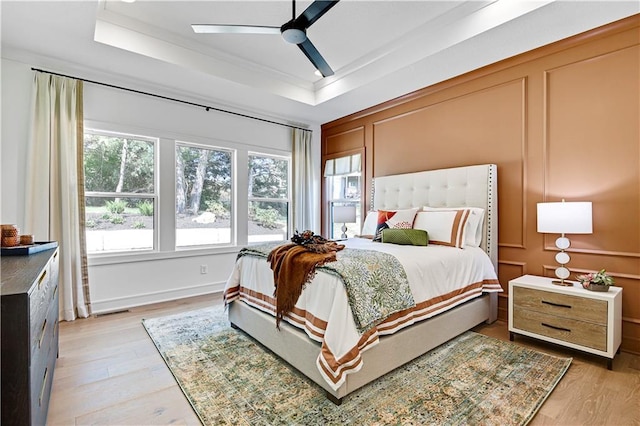 25110 W 98th Pl, Lenexa, KS 66227 - bedroom featuring a raised ceiling, light wood-style floors, a ceiling fan, and ornamental molding