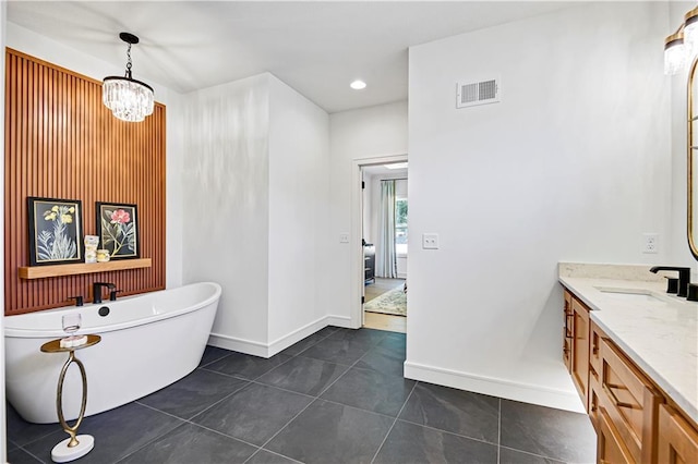25110 W 98th Pl, Lenexa, KS 66227 - bathroom featuring vanity, a freestanding tub, tile patterned floors, a chandelier, and recessed lighting